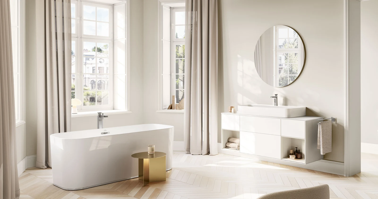 Vea basin faucet on a bright vanity with bathtub Modern bathroom with a freestanding bathtub, large windows, a round mirror, and neutral décor.