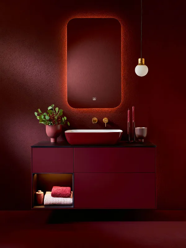 A bathroom with red walls and an Artis washbasin by Villeroy & Boch.