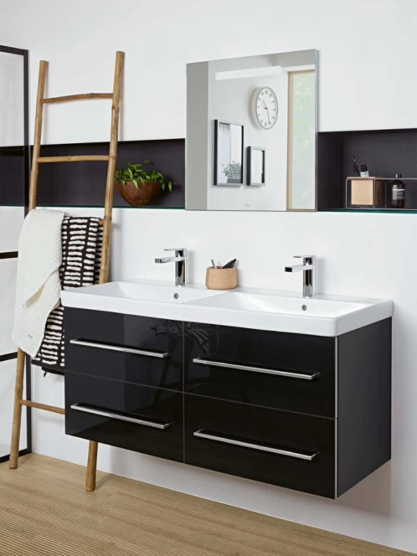 Avento double washbasin with black drawers and a mirror Modern bathroom with an Avento double washbasin with black drawers, a large mirror, a wooden ladder with a white towel, a plant and a clock on the wall.