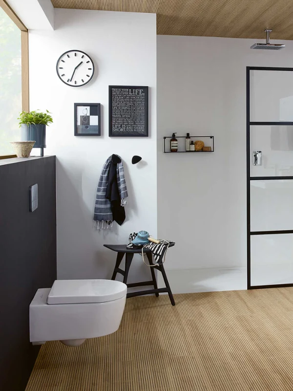 White toilet and a double washbasin in a modern bathroom Modern bathroom with a wall-mounted Avento toilet, a white double washbasin, a glazed shower and wooden elements