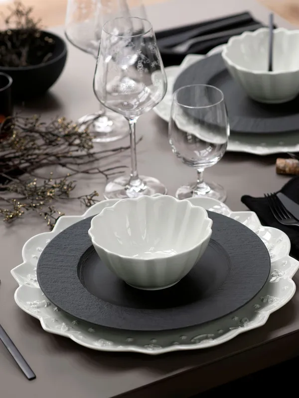 A table set with Villeroy & Boch black Manufacture plates and white Toy’s Delight tableware.