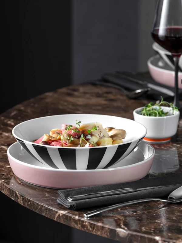 Noodle dishes with La Boule Memphis A La Boule Memphis bowl of noodles with toppings, a glass of red wine, and cutlery on a marble table