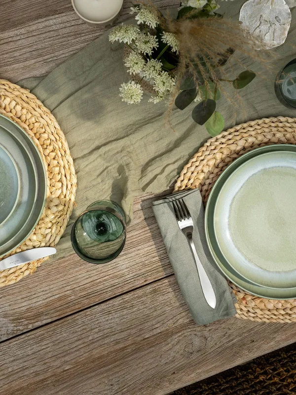 Aerial shot of Perlemor alga on rustic table setting paired with like glassware.