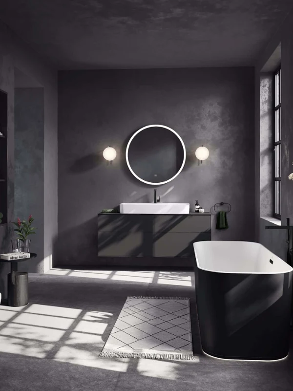 Washbasin in an all-black bathroom All-black sink area with a Finion washbasin and vanity unit, and a black tap on a dark countertop. There is a round mirror above and towels at the side.