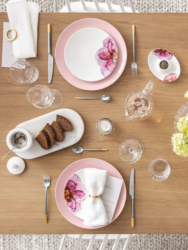 A table set with pink and white plates and flatware from the Rose Garden collection by Villeroy & Boch.