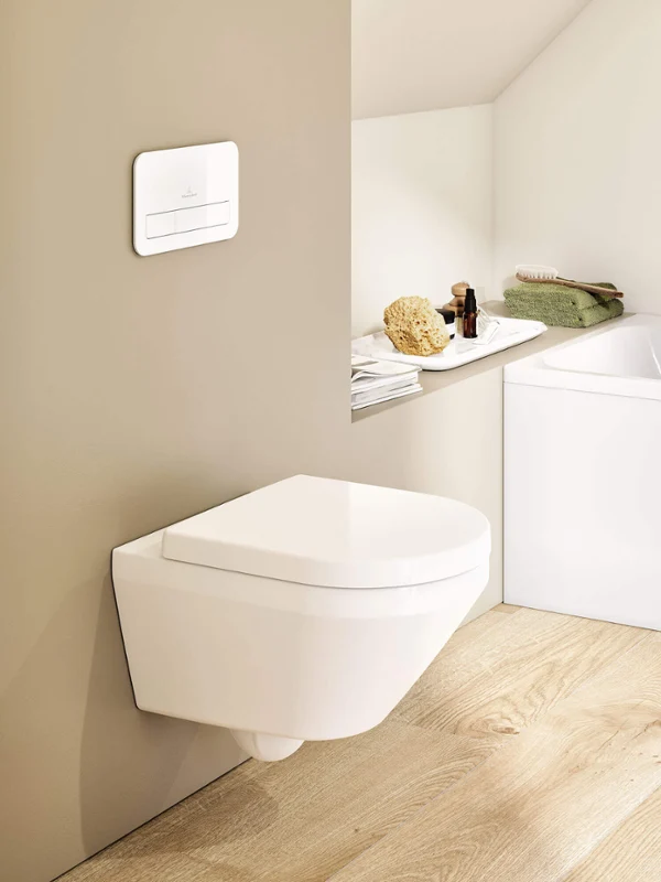 Architectura toilet in a Scandi bathroom A white Architectura toilet with a flush plate in a Scandi-look beige bathroom