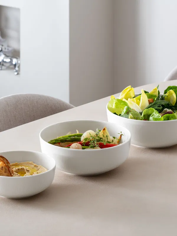 Afina bowls in three different sizes filled with different food.