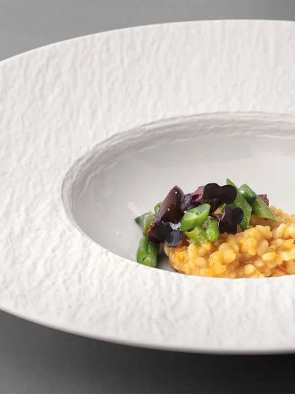 Manufacture pasta plate Manufacture pasta plate with food on it on a grey table.