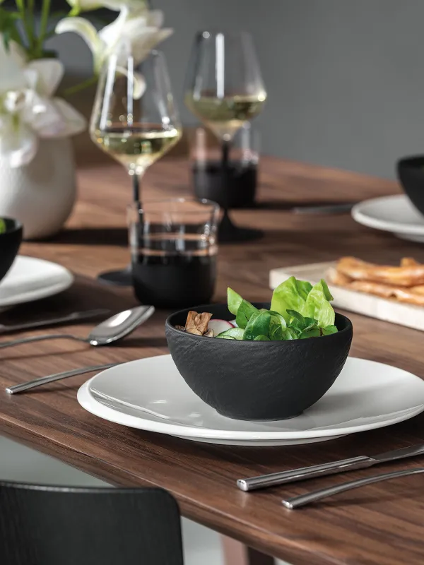 A curated mix of Manufacture Travertine Rock tableware with white Collier vase, styled for a modern home interior.