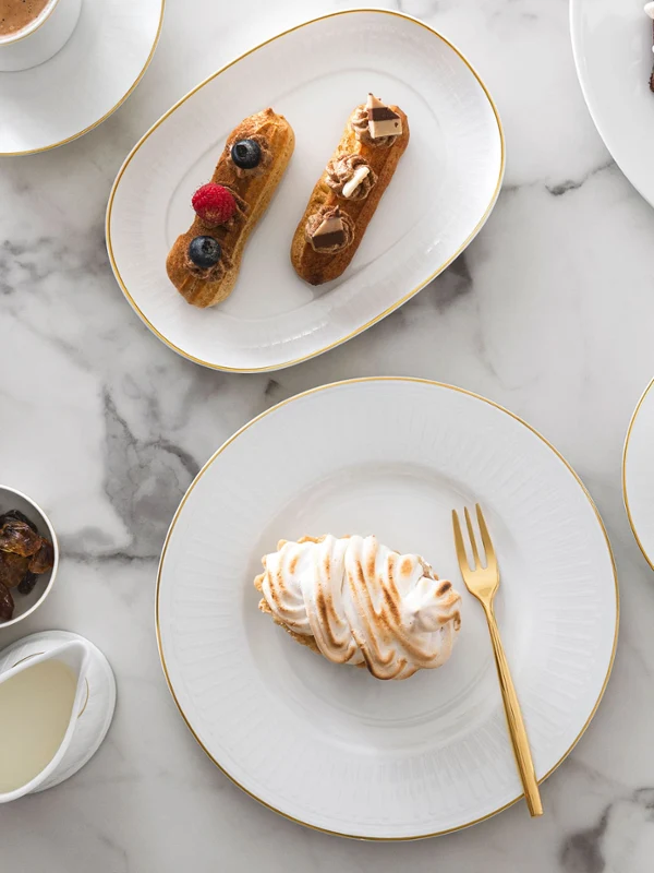 Elegant marble table with Château Septfontaines crockery and gold MetroChic cutlery.