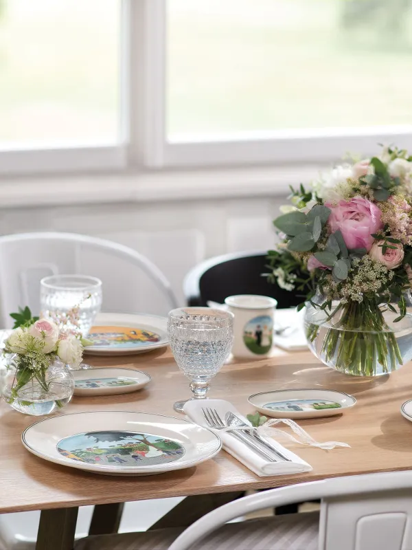 A romantic table setting with Design Naif tableware and NewMoon cutlery along with flowers and candles.