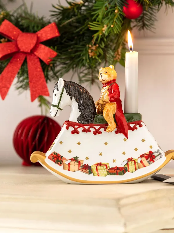 A festive sideboard with a Christmas Toy's rocking horse, a Christmas card and a bowl of nuts.