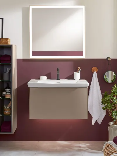 A bathroom with a Subway 3.0 washbasin, mirror and cabinet and a red wall.