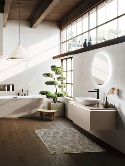 Wanna i umywalka Loop & Friends w łazience w stylu japońskim Minimalistyczna łazienka z drewnianą podłogą i dużymi oknami, wanną wolnostojącą Loop & Friends, umywalką Loop & Friends, małą ławką i drzewkiem bonsai w doniczce.