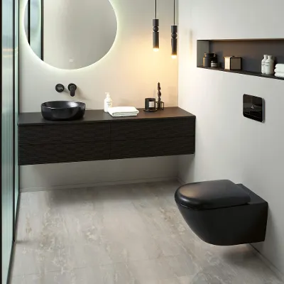 A modern bathroom in a black and white look with a black toilet and washbasin from the Antao collection.