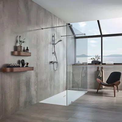 A modern grey bathroom with a Squaro Infinity shower tray and a brown chair.