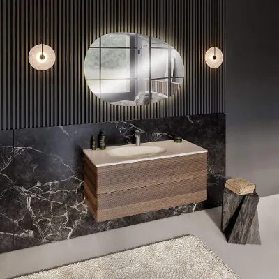 An Antao vanity washbasin with a wood-look vanity unit and an illuminated mirror.