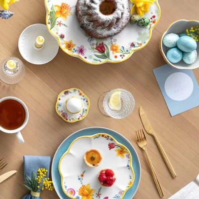 Spring Awakening and Crafted Blueberry crockery on a brunch table setting A spring table setting with Spring Awakening and Crafted crockery, a Bundt cake, a bowl of porridge with berries, a cup of tea and decorative eggs.