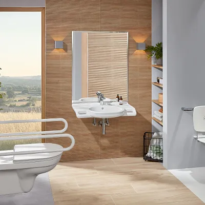 A modern accessible bathroom with a toilet and washbasin from the ViCare collection by Villeroy & Boch.