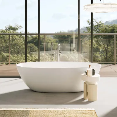 A white Antao bath in a room with a glass wall and trees.