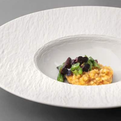 Manufacture pasta plate Manufacture pasta plate with food on it on a grey table.