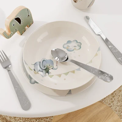 Boho Kids children's crockery on a white table Boho Kids Walk like an Elephant children's crockery set with an elephant pattern on a white table.