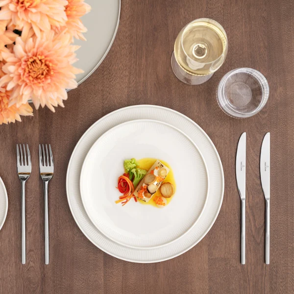A small starter, wine and water will be served on a neatly laid table on Afina dinner plates and silver cutlery.