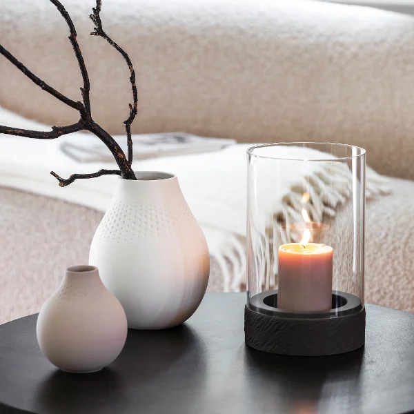 Manufacture Rock Home lantern styled with Collier Perle vases in soft white and beige tones for a serene interior.