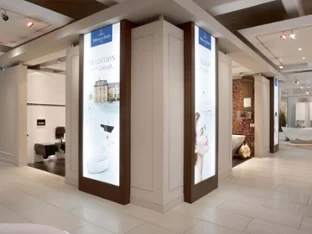Villeroy & Boch showroom with two large screens Modern showroom interior with illuminated bathroom idea displays showcasing the latest Villeroy & Boch products.