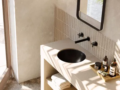 Schwarzes Loop & Friends Waschbecken in modernem beigem Badezimmer Modernes Badezimmer mit beiger Waschtischplatte und schwarzem Loop & Friends Waschbecken. Zu den Accessoires gehören Handtücher und Toilettenartikel.