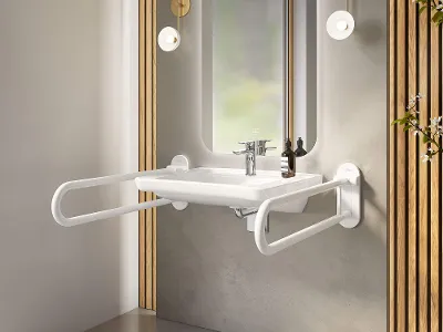 Ein ViCare Waschbecken mit klappbaren Haltegriffen und einem Spiegel mit Ambientebeleuchtung an einer grau verputzten Wand.