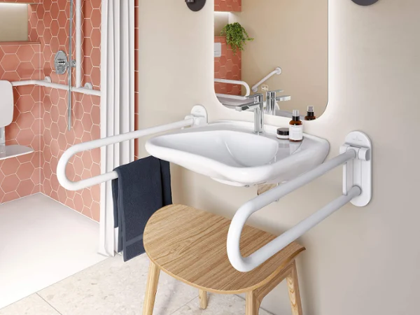 ViCare washbasin with grab handles A ViCare washbasin with an illuminated mirror and two grab handles on the sides. There is a wooden stool under the washbasin.
