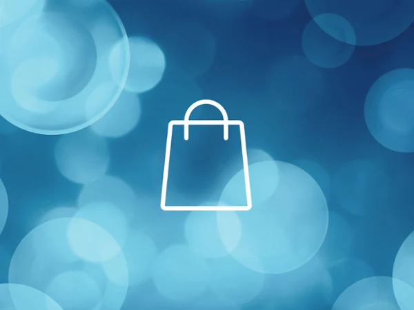 Winter Sale Banner White shopping bag icon centred on a blue background with circular light bokeh effects.