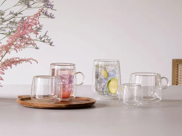 Artesano Hot & Cold Glasses for Espresso and Latte Moments Elegant double-walled glasses from the Artesano Hot & Cold collection by Villeroy & Boch, shown in a cozy setting perfect for enjoying both hot and cold beverages in style.