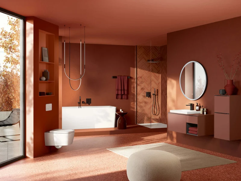 Tivo shower toilet in red bathroom Modern bathroom with pink and brown walls, large window, bathtub, shower, round mirror, and floating washbasin.