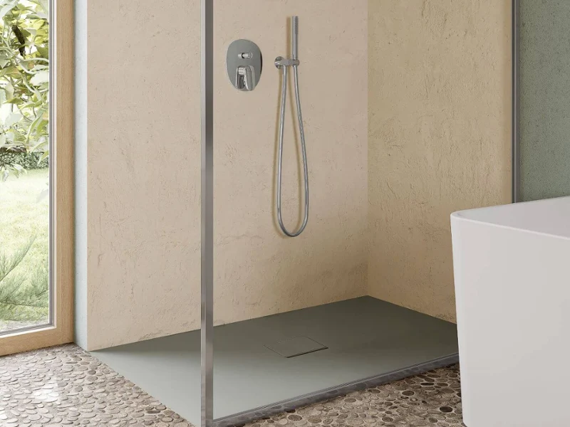 Une salle de bains bohème avec une baignoire en îlot Collaro, un plan double Collaro vert, des WC Venticello et de grandes fenêtres. L’aménagement comprend des plantes, de l’art mural et des textures naturelles.