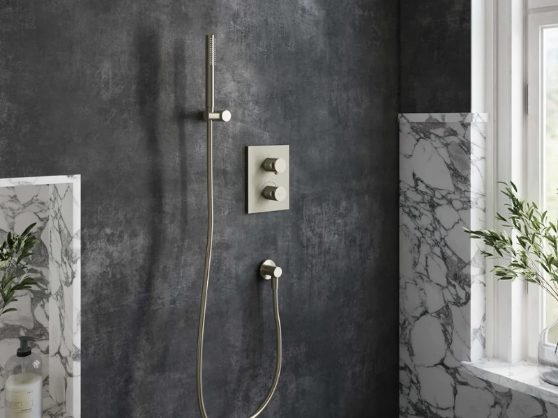 Universal Showers shower fitting in a dark bathroom Modern shower with rain showerhead and hand shower in a dark-tiled bathroom with a window and plants.