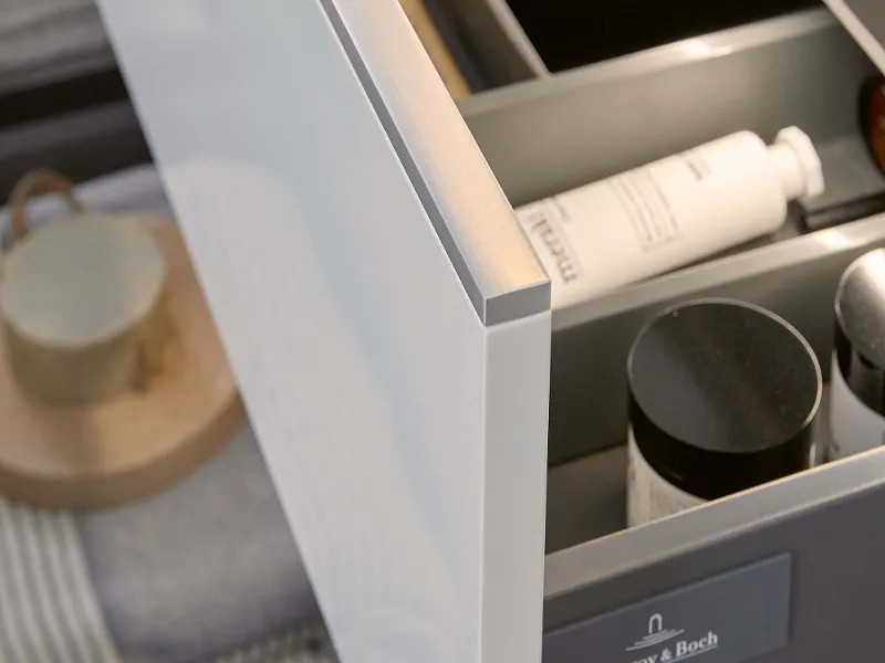 An open drawer on a white Subway 3.0 vanity unit and an object inside.