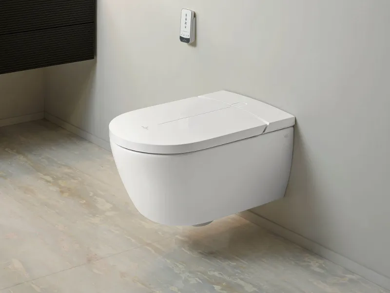 A modern bathroom with a ViClean shower toilet including remote control by Villeroy & Boch.