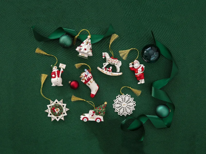 Annual Christmas Edition 2024 Christmas decoration with a Father Christmas, a snowflake and a rocking horse on a green background with green ribbon and bauble-shaped decorations.