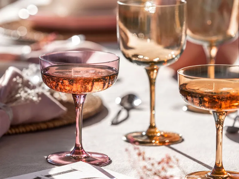 A table set with like. by Villeroy & Boch wine glasses and champagne coupes.