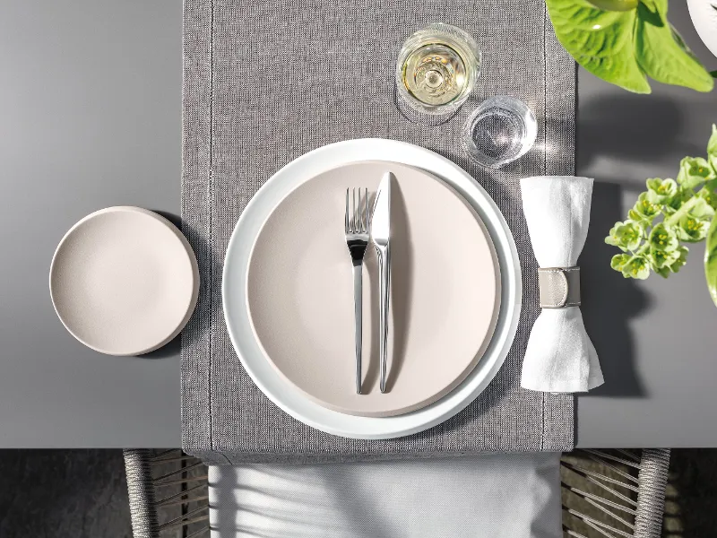 A table set with Villeroy & Boch NewMoon tableware and cutlery.