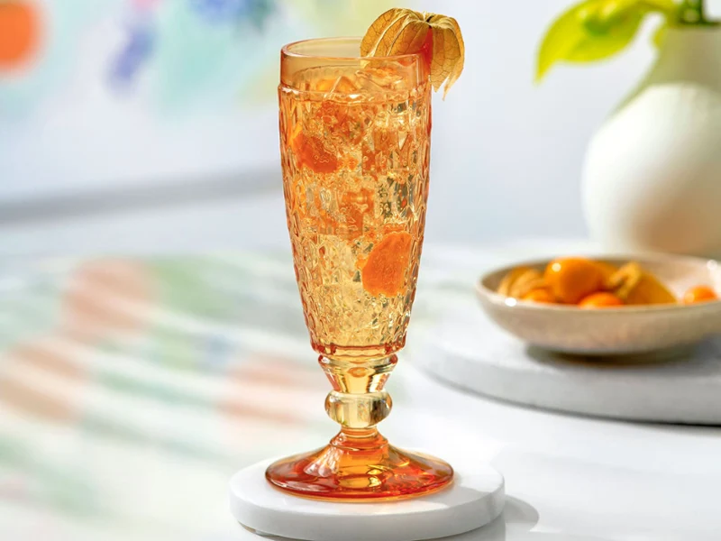 An orange champagne glass from Villeroy & Boch on a table.