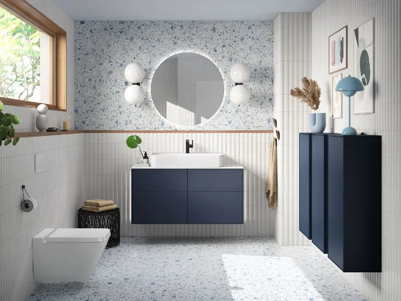 Finion Midnight Blue Matt vanity unit and wall cabinet in a modern bathroom with light-blue accents by Villeroy & Boch.