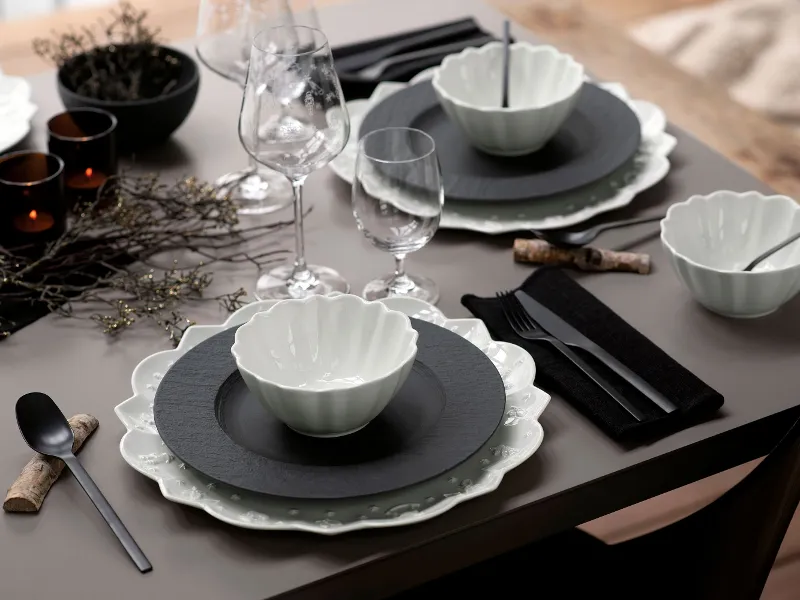 A table set with Villeroy & Boch black Manufacture plates and white Toy’s Delight tableware.