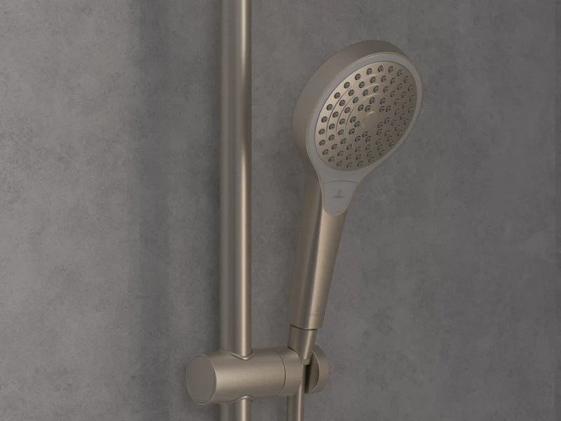 Verve Shower hand shower in classic chrome A close-up of a modern chrome hand shower head mounted on a vertically adjustable rail in front of a grey tiled wall.