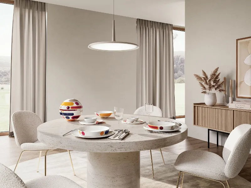 Modern dining room with La Boule Miami on a round table surrounded by elegant chairs.