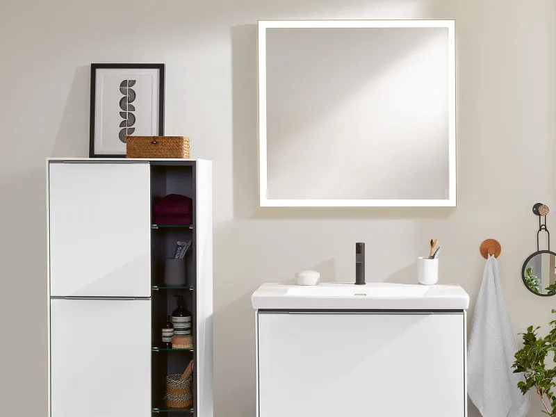 A Subway 3.0 mirror with white furniture on a beige wall.