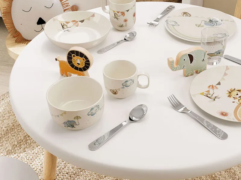 A table setting in a children's room with Boho Kids crockery, cutlery and glasses in an animal theme in pastel colours.