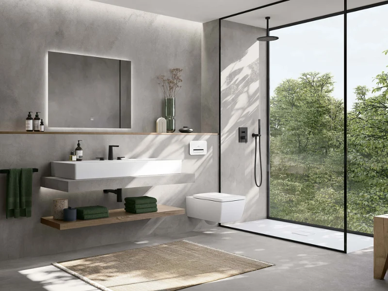 White Memento 2.0 washbasin in concrete-look bathroom Modern bathroom with concrete walls, floating washbasin, glass shower, large window, and green accents.